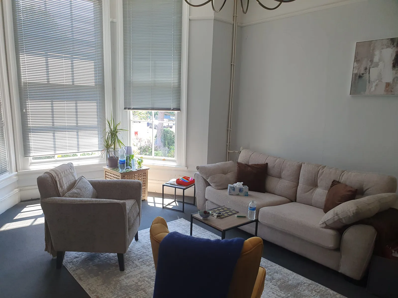 Bright bay-window light over the seating area in the Marlow consulting room.