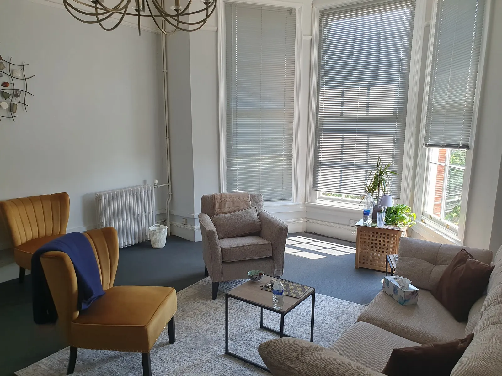 The full Marlow consulting room with bay windows letting in soft daylight.